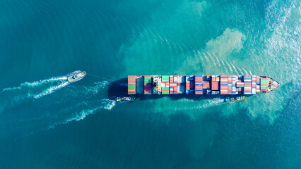 Aerial of cargo ship carrying container for export cargo from cargo yard port to other ocean...