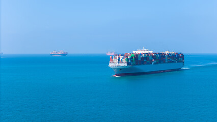 Aerial of cargo ship carrying container  for export cargo from cargo yard port to other ocean...