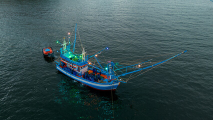 Fishing boat go to ocean for catching fish all a long night - at Thailand. Top view of Fishing Boat running verry fast on the sea to port.