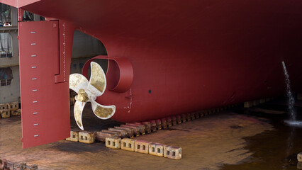 Propeller of large ship spinning power working and water splash contrail . Close up image detail...