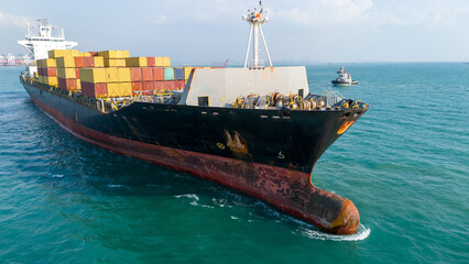 Aerial of cargo ship carrying container export cargo from cargo yard port to other ocean concept...
