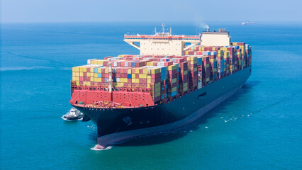 Aerial of cargo ship carrying container  for export cargo from cargo yard port to other ocean...