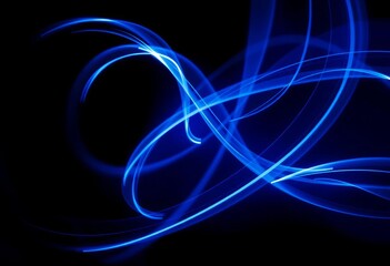 Abstract swirling blue light streaks on a dark background, creating a dynamic and energetic template,  abstract,  pattern