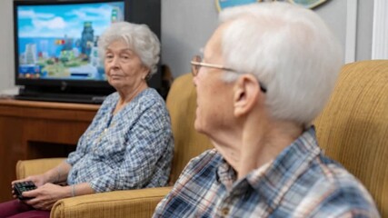 Leisurely Moments: Two senior citizens are engrossed in a video game, revealing the joy of youthful exuberance and a testament to the joys of staying connected. - Powered by Adobe