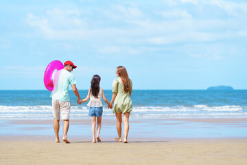 Beach Family Vacation in Summer, Happy Parents Holding Hands with Daughter Walking Together on Sandy Shoreline in Relaxing Outdoor Holiday Moment