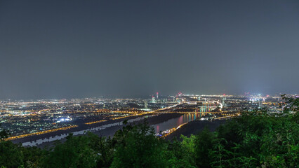 Skyline of Vienna from Danube Viewpoint Leopoldsberg aerial night timelapse.