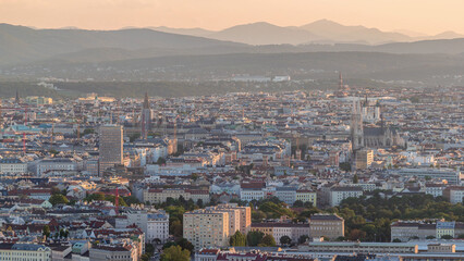 Aerial panoramic view of Vienna city with skyscrapers, historic buildings and a riverside promenade timelapse in Austria.