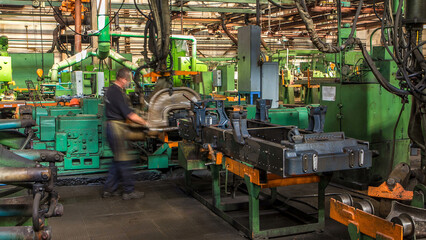 Conveyor assembly stage the body of tractor at big industrial factory timelapse