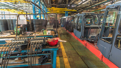 Conveyor assembly stage the body of tractor at big industrial factory timelapse