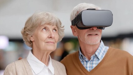 Senior Couple Exploring Virtual Reality: An elderly couple, eyes filled with curiosity, explores a new dimension through virtual reality technology, embracing the wonders of innovation.