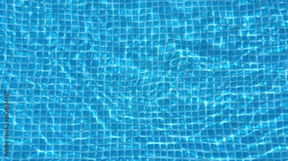 Poster light reflecting and refracting on the rippling surface of a swimming pool creates a mesmerizing pat