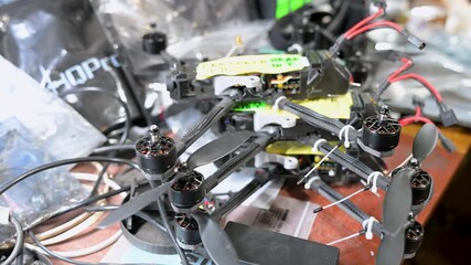 A detailed close-up of an FPV 'kamikaze' drone being assembled in a Ukrainian workshop. This low-cost, expendable tech provides a key tactical advantage on the modern battlefield. - Powered by Adobe