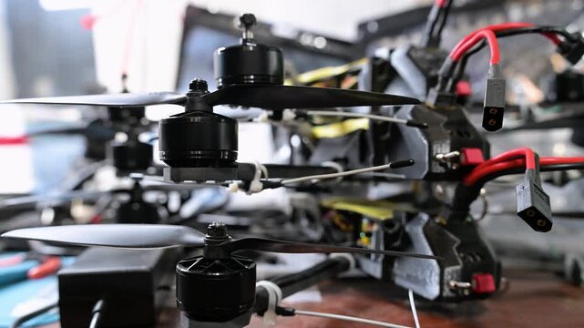 This close-up shot shows civilian drone technology being repurposed for military use in Ukraine, as soldiers assemble FPV drones into combat-ready assets for the war with Russia.