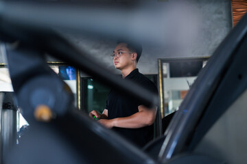 Man working out in a gym while focused on personal fitness goals during the afternoon hours in a...