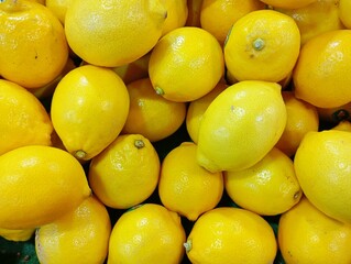 Fresh Yellow Lemons Background. Pile of Ripe Citrus Fruit. Healthy Lemons at the Market. Vibrant Lemon Fruit Close-up. Natural Organic Lemons for Sale
