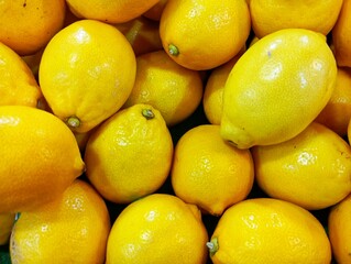 Fresh Yellow Lemons Background. Pile of Ripe Citrus Fruit. Healthy Lemons at the Market. Vibrant Lemon Fruit Close-up. Natural Organic Lemons for Sale
