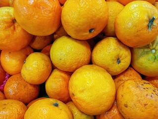 Fresh Oranges Background. Pile of Ripe Citrus Fruit. Healthy Oranges at the Market. Vibrant Oranges Fruit Close-up. Natural Organic Oranges for Sale