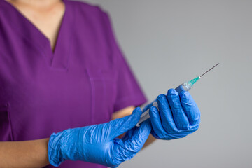 Doctor preparing syringe for injection, vaccination or medical procedure