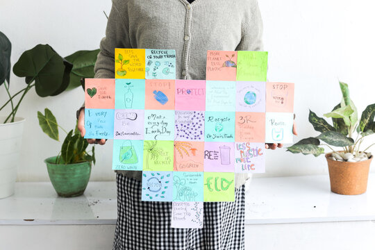 Hands Holding Poster With Collection Of Promoting Recycle Practices, Call To Protect The Planet - Powered by Adobe