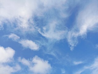 Blue Sky with White Clouds. Peaceful Daytime Skyscape. Natural Cloud Formations. Wispy Clouds on a...