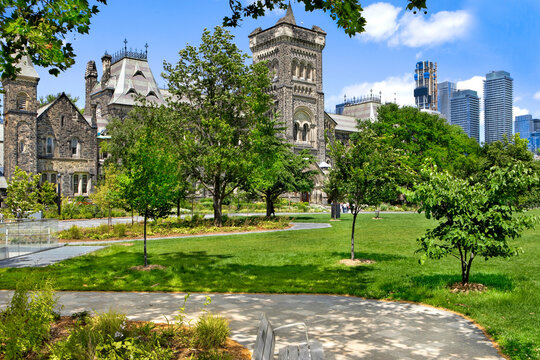 The University College Building at the St.George campus of The University of Toronto with walkway and lawn in the foreground 