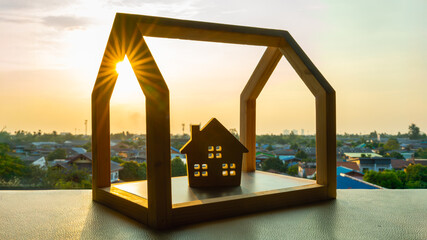 Wooden house model on wood table, a symbol for construction , ecology, loan, mortgage, property or...