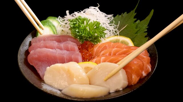 Chopsticks Picking Tuna Sashimi from Japanese Sushi Set