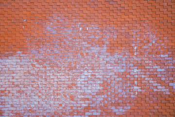 Close-up of a grunge, weathered red brick or tile wall surface with white efflorescence stains....