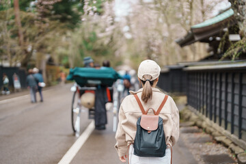 Woman tourist sightseeing Sakura Cherry Blossom in Spring. Happy traveler travel in Samurai village...