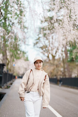 Woman tourist sightseeing Sakura Cherry Blossom in Spring. Happy traveler travel in Samurai village...
