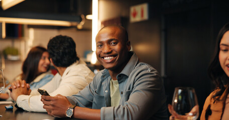 Happy, portrait and man with phone in restaurant for social media, online message and conversation....