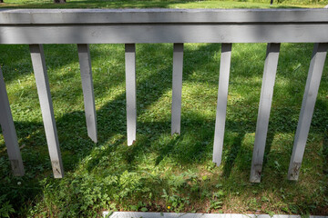 broken white wooden fence against green lawn