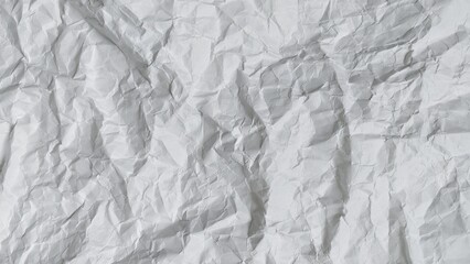 Obraz premium Crumpled white paper texture background with wavy surface. Crumpled white vintage paper surface texture for background. Wrinkled paper, abstract background. Paper background with copy space for text.