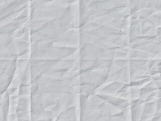 Crumpled white paper texture with fold lines. Crumpled blank white paper folded in four fraction...