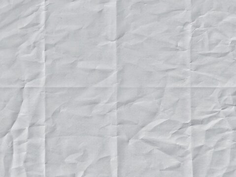 Crumpled white paper texture with fold lines. Crumpled blank white paper folded in four fraction background. Ideal for backgrounds, overlays, space for text, space for advertising copy.
