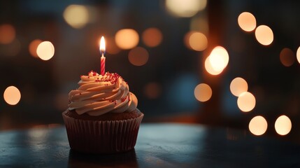 Delicious birthday cupcake with lit candle on wooden table, warm festive bokeh lights in background, celebration dessert for party invitation or holiday greeting design




