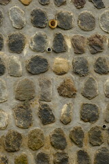 cement walls with a mixture of large andesite stones.