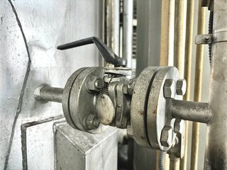 old water pump.  metal valve with corrosion and rust on industrial pipe system, showing vintage engineering, mechanical details, and need for maintenance or repair in factory operations.