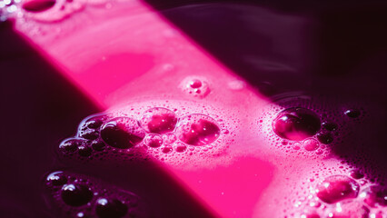 Pink Bubbly Liquid Abstract, Close-up abstract image of vibrant pink liquid filled with numerous small, shimmering bubbles.