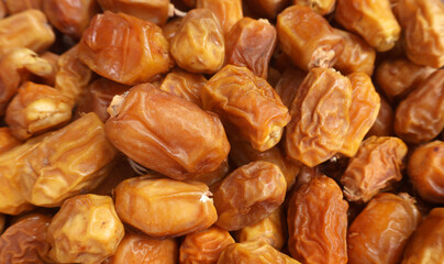 selective image of Pile of Kurma or Dates Fruits on the Karachi Ramadan market, fresh and dried dates background