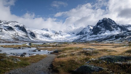 Snowy mountain range, alpine lake, and trail
