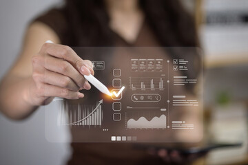 Businesswoman analyzing data with stylus on virtual digital dashboard