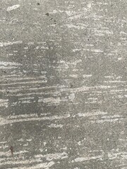 Close-up of textured concrete surface showing light streaks and patterns.