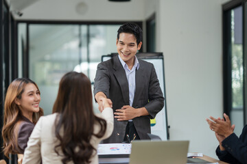 Asian business group is happy to join hands to show success in their careers.
