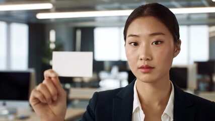 Businesswoman holding blank card in office