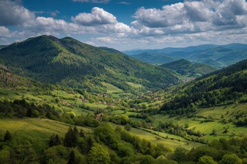 Naklejka premium Lush green mountains and valleys under a partly cloudy sky, dotted with small houses and dense forests in a peaceful landscape