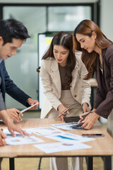 Group of business people are standing in a meeting presenting their work at the office.
