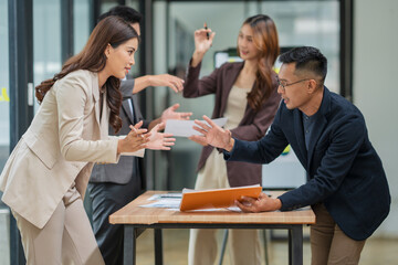 Group of business people are standing in a meeting presenting their work at the office.