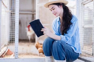 Young woman generation z scientist on farm using tablet for agricultural education outdoor with...