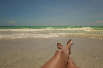 Legs and feet in sand beautiful beach scene Anna Maria Island